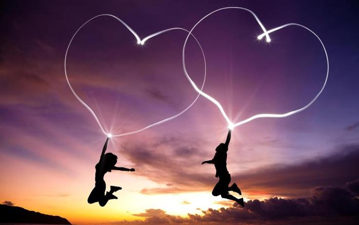 two silhouettes of man and a woman suspended in the air by floating hearts